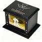Black pet urn with a photo of a dog and an engraved message on a white background