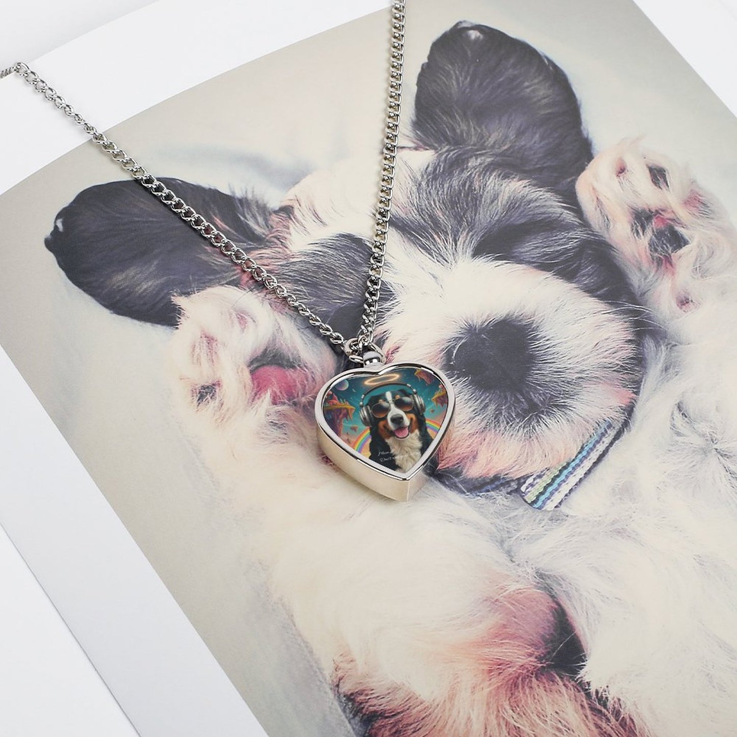 Heart-shaped locket with a dog's face on it, placed on a photo of a dog lying down.